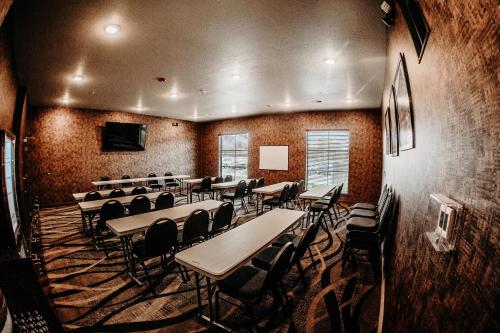 a conference room with tables and chairs and a television at Cobblestone Hotel & Suites International Falls in International Falls
