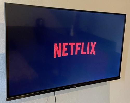 a television screen with the netflix logo on it at Fare Ihilei in Fare