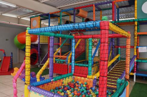 an indoor play room with a large play structure with balls at Hotel Premium Campinas in Campinas