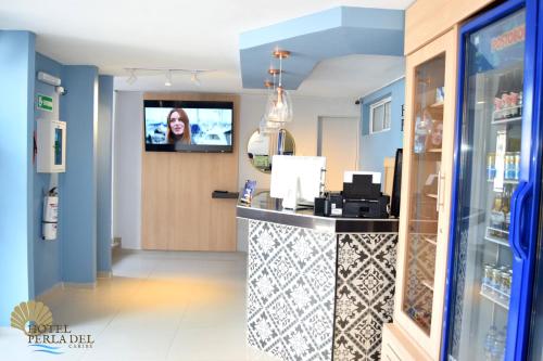 TV a/nebo společenská místnost v ubytování Hotel Perla del Caribe