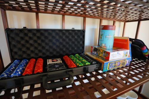 a shelf with dominoes and other toys on it at Henderson Hacienda, 5br free heated pool-spa, 15 min to Strip in Henderson