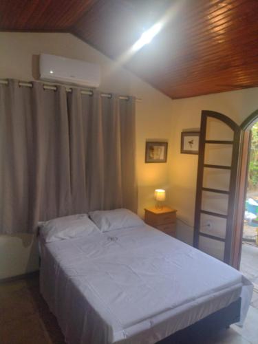 a bedroom with a bed and a ladder in it at RESONAMUH - Hostel in São Pedro da Aldeia