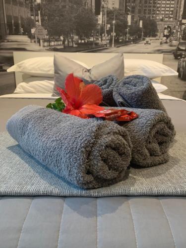 a pile of towels and flowers on a bed at 27 Pinehurst in White River