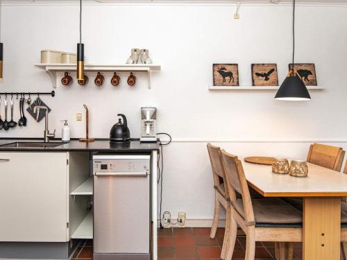 a kitchen and dining room with a table and chairs at 4 person holiday home in Fanø-By Traum in Fanø