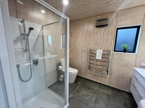 a bathroom with a shower and a toilet at Wayfarer Lodge Studio in Lake Tekapo