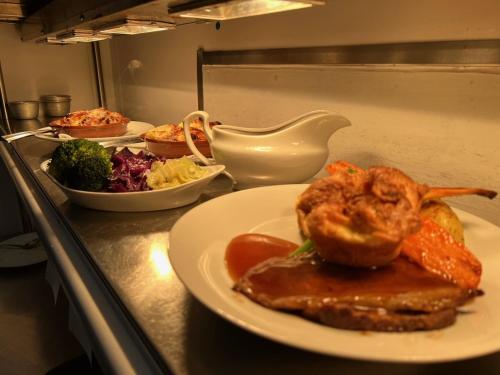 a table with a plate of food on a counter at Creates in Monmouth
