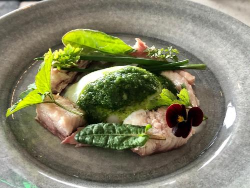 a plate of food with meat and vegetables on it at Sydkustens at Pillehill in Skivarp