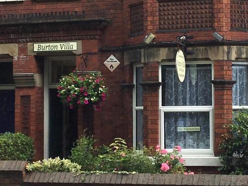 a brick building with a window with a sign on it at Burton Villa Guest House in York