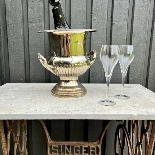 a table with a champagne bottle and two wine glasses at Sydkustens at Pillehill in Skivarp