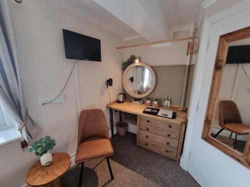 a room with a desk with a mirror and a chair at Creates in Monmouth