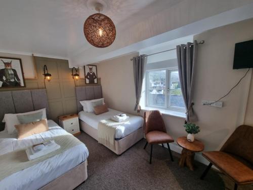 a hotel room with two beds and a window at Creates in Monmouth