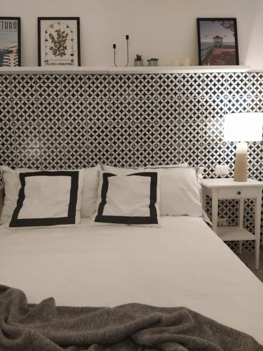 a bed with two pillows on it in a bedroom at Nova Rua in Amalfi