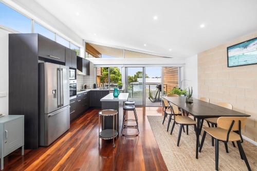 a kitchen and dining room with a table and chairs at Beach Baby in Aireys Inlet