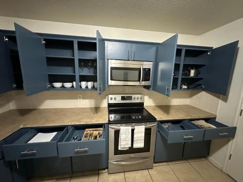 a kitchen with blue cabinets and a stove at Zen Space @ Harker Heights in Harker Heights
