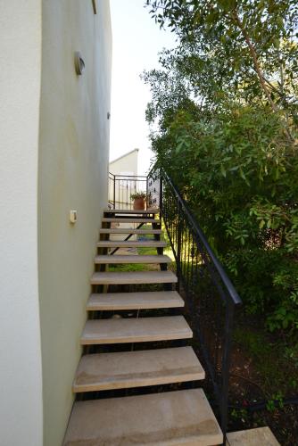 a set of stairs leading up to a building at Rothschild Galilee Hospitality in Hagoshrim
