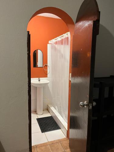 a bathroom with a shower and a sink at Casa Makoi in Tamanique