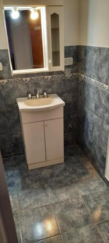 a bathroom with a sink and a mirror at Casa Los Zorzales in San Pedro