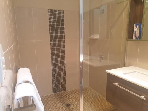 a bathroom with a shower and a sink at Cobar Central Motor Inn in Cobar