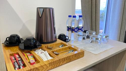 a table with a coffee maker and bottles of water at Alimas Holiday Retreat Maldives in Felidhoo