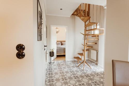 a hallway with a spiral staircase and a bedroom at Waldchalet Am Steinberg FEWO in Wernigerode