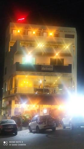 a building with cars parked in front of it at night at Pousada Mariza in Guarabira