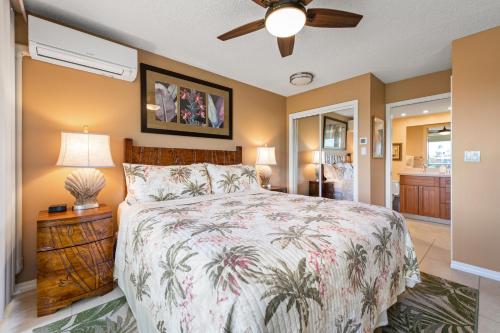 a bedroom with a bed and a ceiling fan at Maui Banyan H311 1BD 2BA 3 min walk to the beach in the Heart of South Kihei! in Wailea