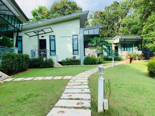 a house with a stone path in front of it at Snapper House in Khao Lak