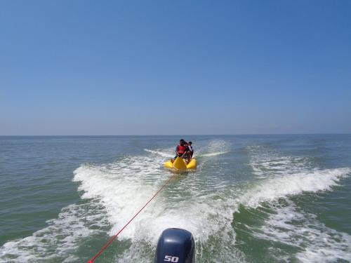 two people on a yellow boat in the ocean at Cherai Blue View Beach Resort in Cochin