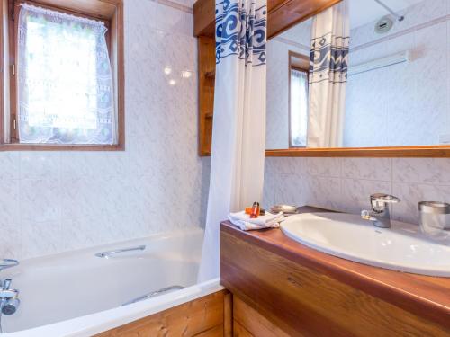 a bathroom with a sink and a tub and a mirror at Appartement Val-d'Isère, 3 pièces, 6 personnes - FR-1-694-103 in Val-d'Isère