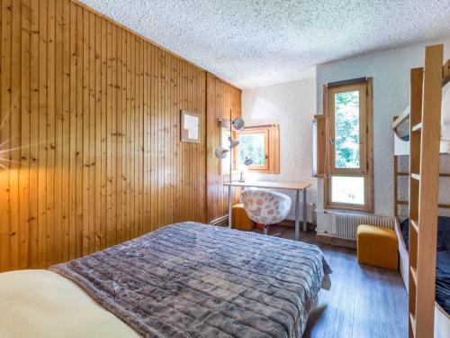 a bedroom with a bed and a wooden wall at Appartement Val-d'Isère, 3 pièces, 6 personnes - FR-1-694-111 in Val-d'Isère