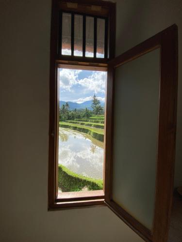 a window in a room with a view of a river at Lesong Hotel and Restaurant in Munduk