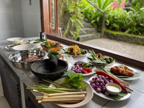 a buffet with many plates of food on a table at Lesong Hotel and Restaurant in Munduk
