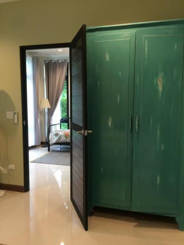 a room with a green closet and a door at Snapper House in Khao Lak