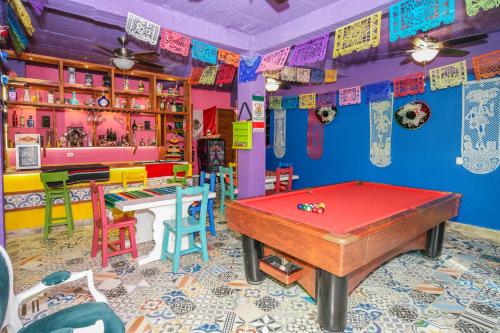 a room with a pool table and many colorful chairs at San Miguel de Montenegro in Montenegro