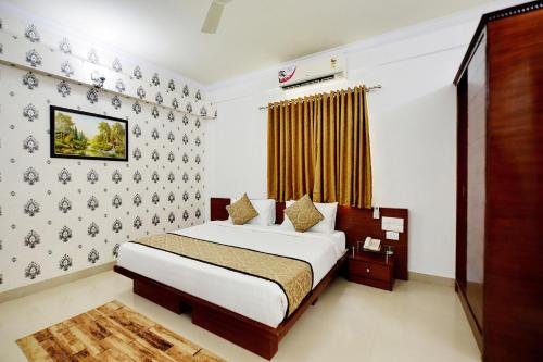 a bedroom with a bed and a wall at The Liverpool Blue Hotels in Bengaluru