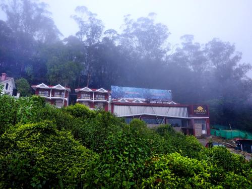 a group of buildings on top of a hill at Vista Suites Doddabetta Ooty By Bestinn Leisure in Ooty