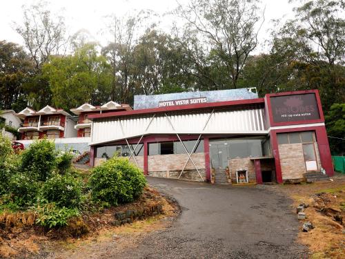 a building with a sign on the front of it at Vista Suites Doddabetta Ooty By Bestinn Leisure in Ooty