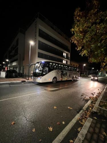 a bus driving down a city street at night at Donati Business Rooms in Subbiano