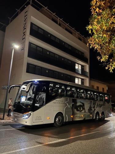 a bus parked in front of a building at night at Donati Business Rooms in Subbiano