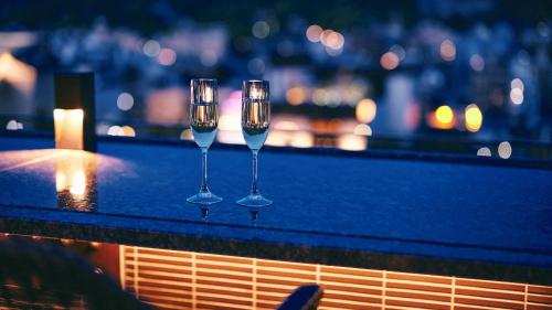 three wine glasses sitting on top of a ledge at Sora Niwa Terrace Kyoto Bettei in Kyoto