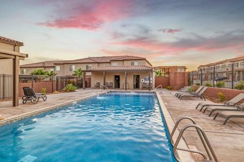 a swimming pool with chairs and a house at St George, private hot tub/patio, new community in Washington