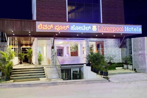 a building with a sign for a hotel at The Liverpool Blue Hotels in Bengaluru