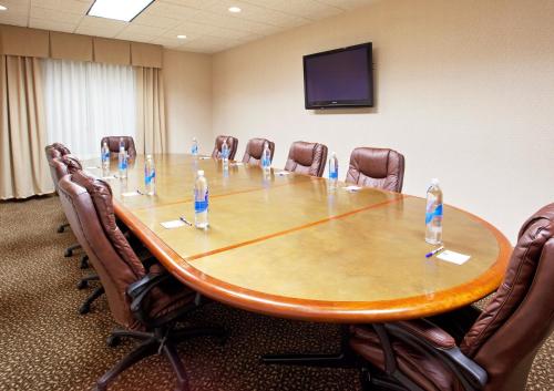 a conference room with a table and chairs with water bottles on it at Holiday Inn Express Hotel & Suites Howell by IHG in Howell