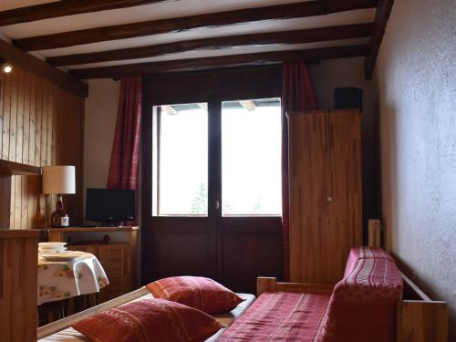 1 dormitorio con cama y ventana grande en Appartement Méribel, 1 pièce, 4 personnes - FR-1-180-51, en Méribel