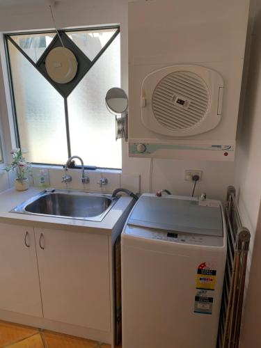 a small kitchen with a sink and a window at Fremantle Accommodation Villas in Fremantle