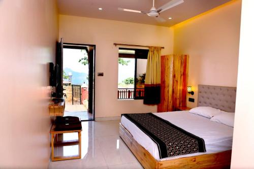 a bedroom with a bed and a television in it at Sara green Valley Farm in Mahabaleshwar