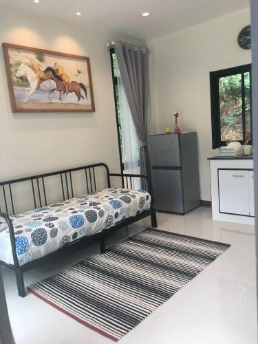 a bedroom with a bed and a rug at Snapper House in Khao Lak
