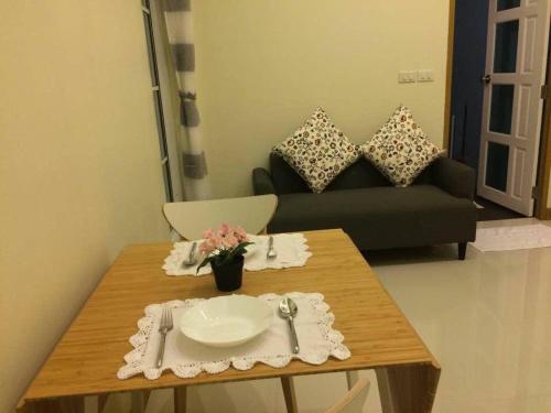 a table in a living room with a couch at Snapper House in Khao Lak