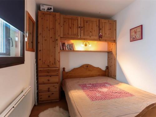 a small bedroom with a bed and wooden cabinets at Val Thorens - Appartement 4 pers, 2 pièces rénové, plein centre - FR-1-637-53 in Val Thorens