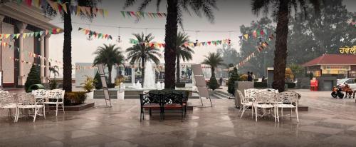 a group of tables and chairs in a courtyard with flags at Mannat Haveli in Kurukshetra